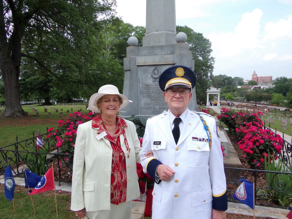 LTC Ross Glover, Old Guard representative and Mrs. Julia Sapp, President of the Kennesaw Chapter no. 241, United Daughters of the Confederacy stand before Confederate Memorial at the Confederate Cemetery in Marietta